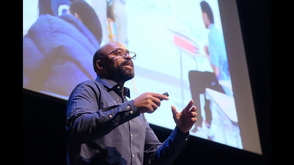 Eli Davis speaking on stage