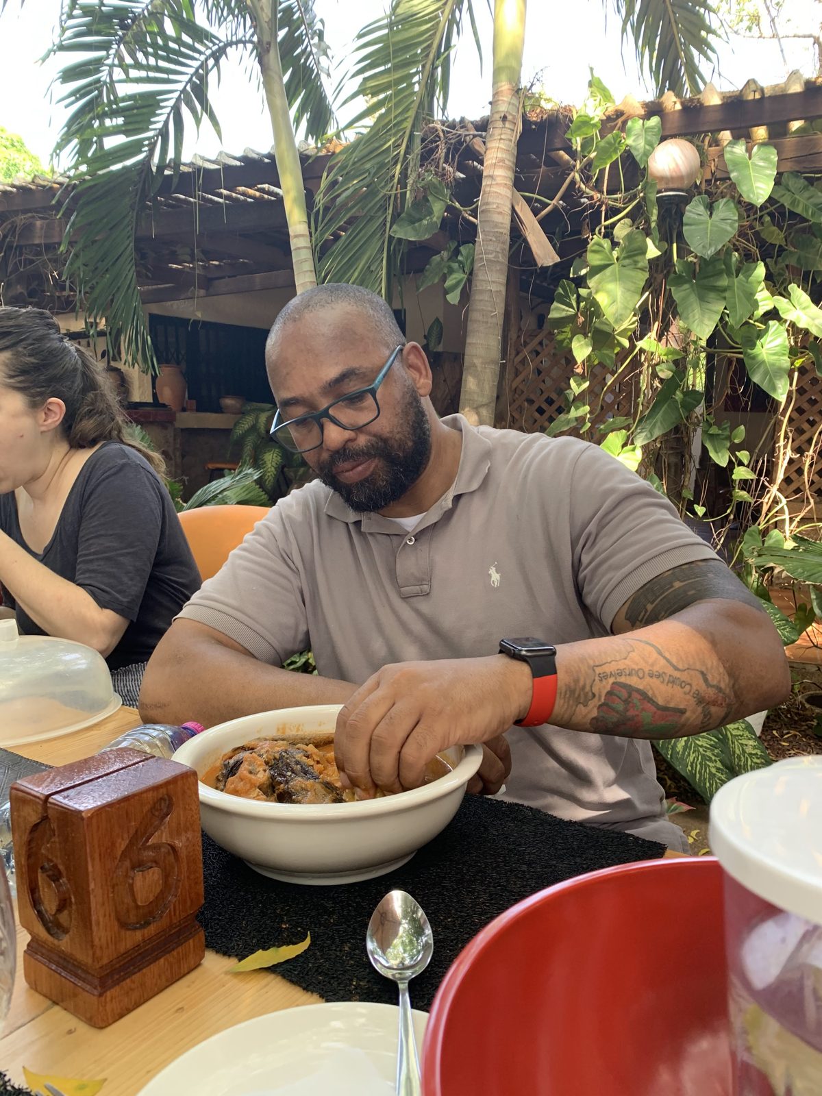Eli Davis eating fish-stock pepper soup with his hands at the W. E. B. Du Bois House in Accra, Ghana